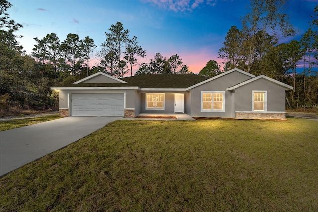 single story home featuring stone siding, an attached garage, concrete driveway, and stucco siding