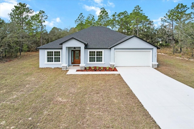 view of front facade featuring a garage, concrete driveway, a shingled roof, and a front lawn