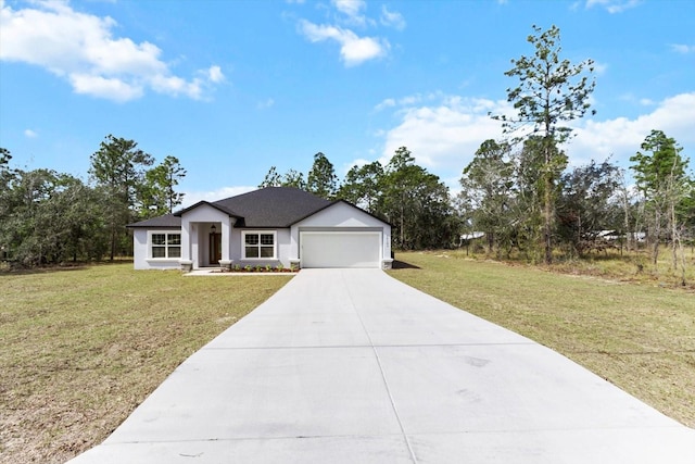 view of front of house featuring driveway, an attached garage, and a front yard