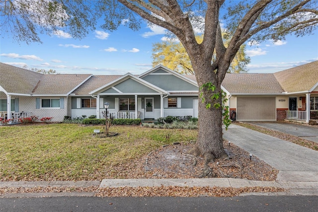 ranch-style house featuring driveway, stucco siding, a front yard, a porch, and brick siding