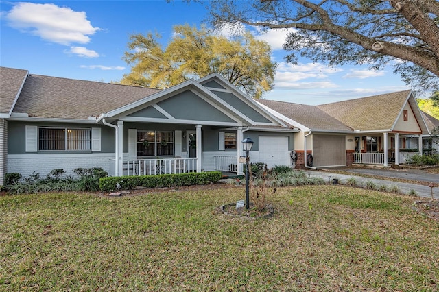 ranch-style house with a garage, covered porch, a front lawn, and brick siding