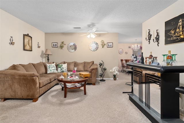living area with carpet flooring, visible vents, a textured ceiling, and ceiling fan with notable chandelier