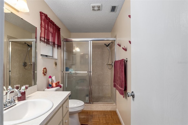 full bathroom featuring a shower stall, a textured ceiling, and vanity