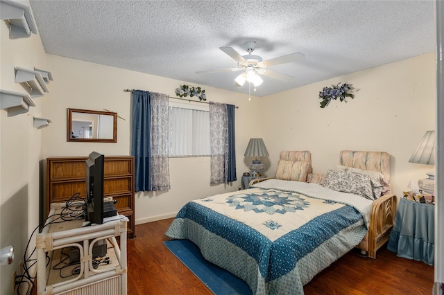 bedroom featuring a textured ceiling, ceiling fan, and wood finished floors
