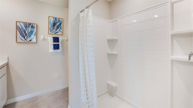 full bath with curtained shower, tile patterned floors, vanity, and baseboards