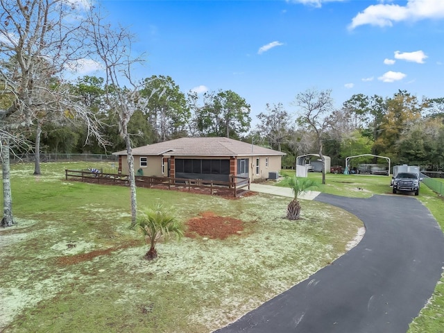 view of front of property with driveway, a front yard, and fence