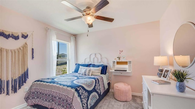 bedroom with a ceiling fan, light colored carpet, and baseboards