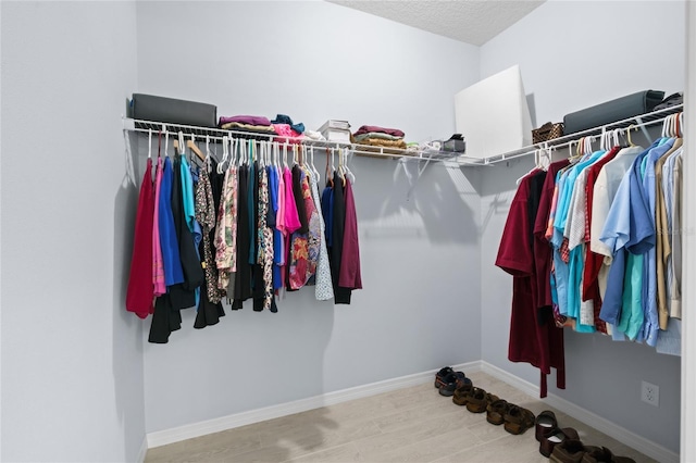 spacious closet with wood finished floors