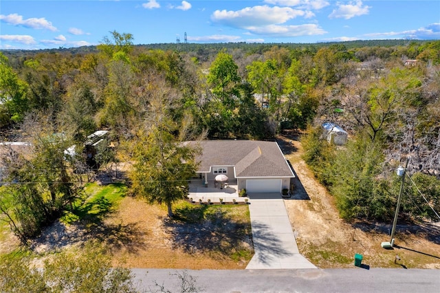 aerial view featuring a wooded view