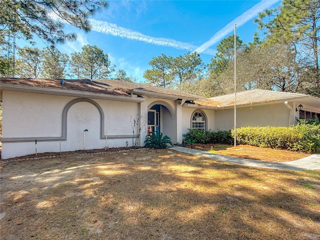 ranch-style house featuring stucco siding