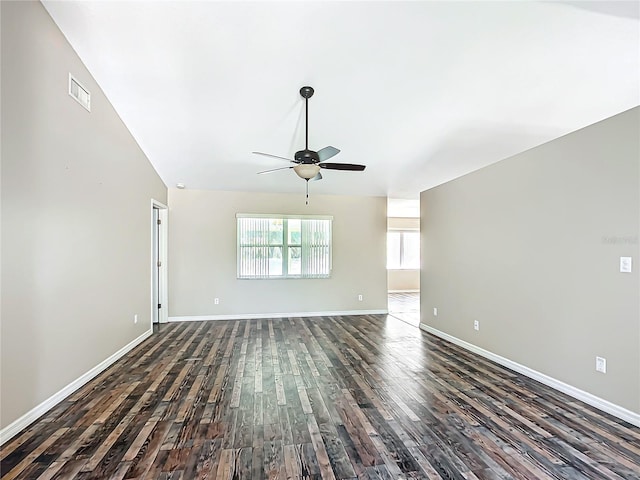 unfurnished room featuring ceiling fan, lofted ceiling, visible vents, baseboards, and dark wood finished floors