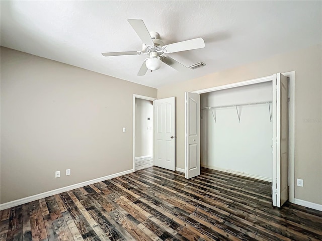 unfurnished bedroom with baseboards, visible vents, and dark wood-type flooring