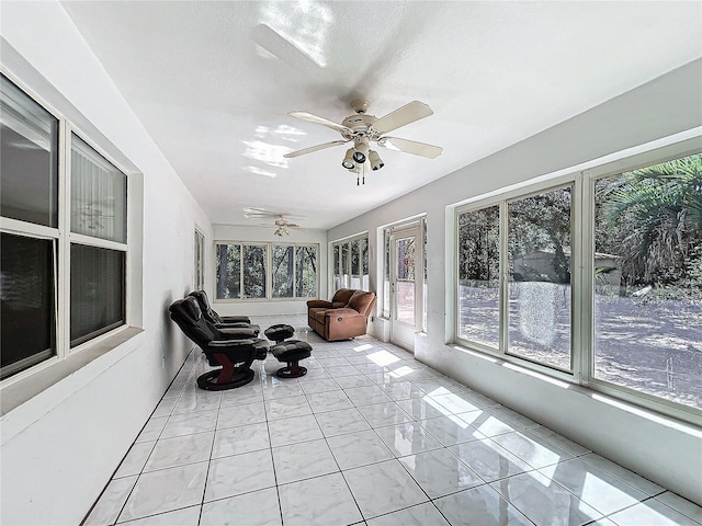 sunroom featuring ceiling fan