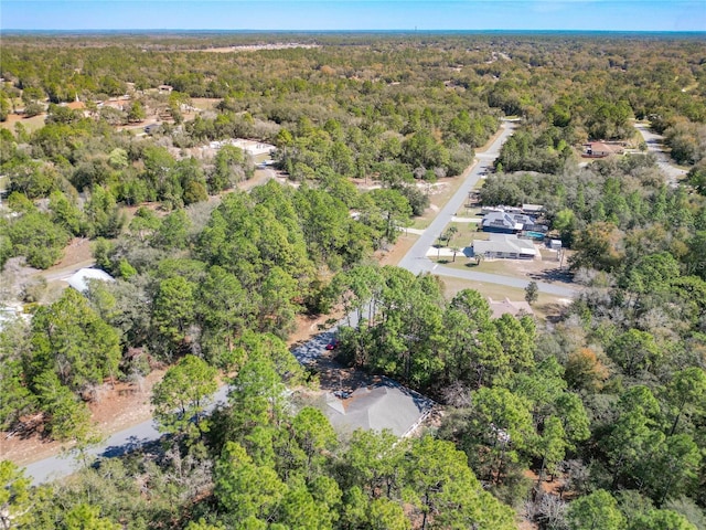 drone / aerial view featuring a view of trees