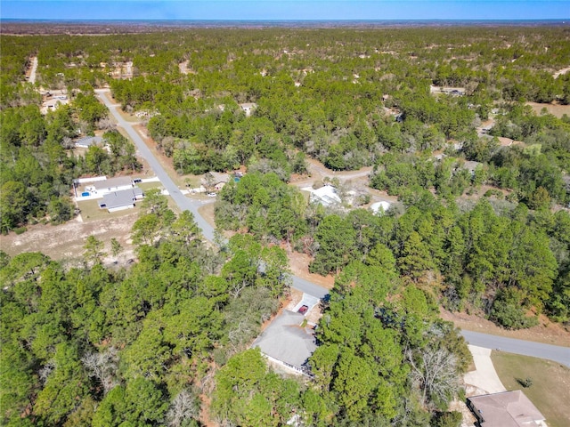 birds eye view of property featuring a view of trees