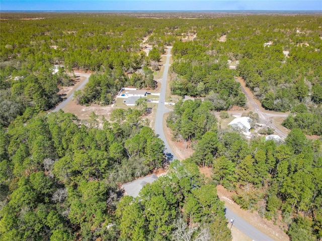 drone / aerial view featuring a forest view