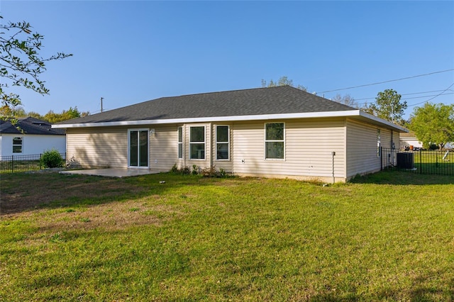 rear view of property featuring a fenced backyard, a yard, and a patio