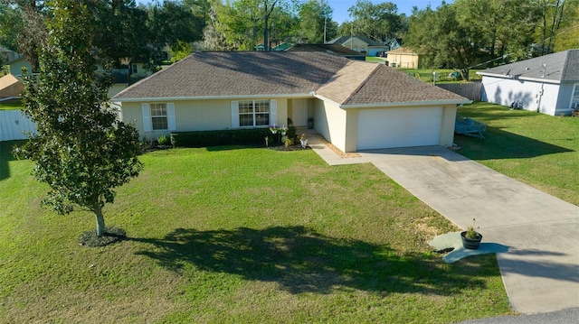 ranch-style house with an attached garage, driveway, a front yard, and stucco siding