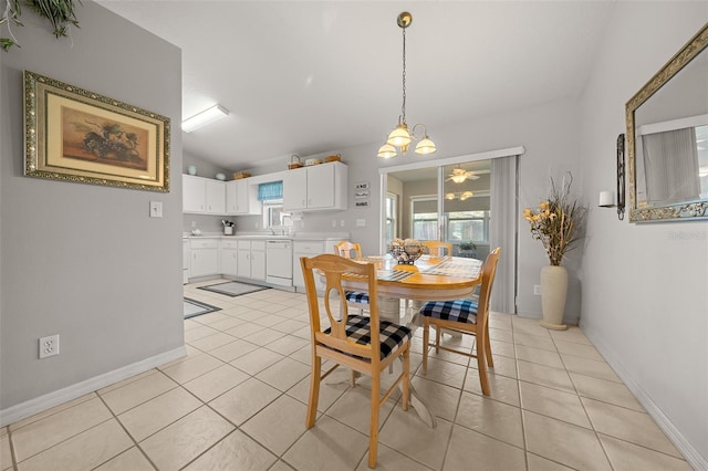 dining room featuring lofted ceiling, light tile patterned floors, and baseboards