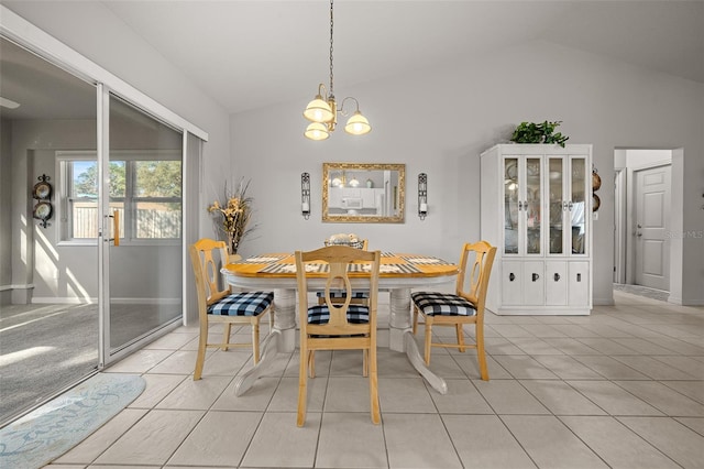 dining room featuring lofted ceiling, light tile patterned floors, and an inviting chandelier