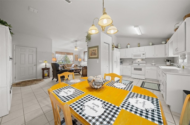 dining space featuring lofted ceiling, visible vents, ceiling fan, and light tile patterned floors