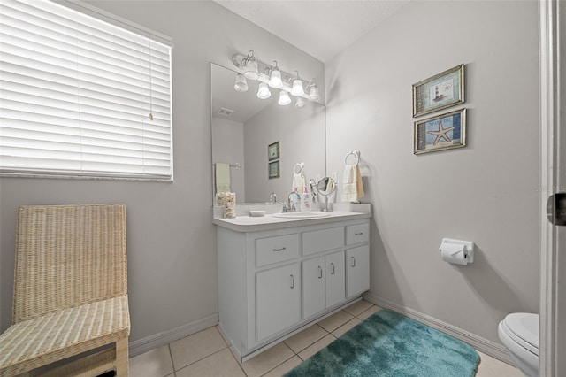 bathroom with toilet, tile patterned flooring, baseboards, and vanity