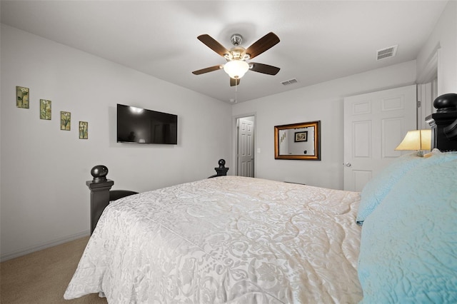 carpeted bedroom featuring a ceiling fan, visible vents, and baseboards