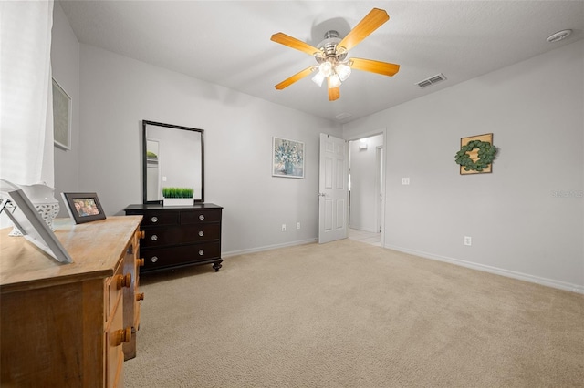 bedroom featuring baseboards, visible vents, a ceiling fan, and light colored carpet