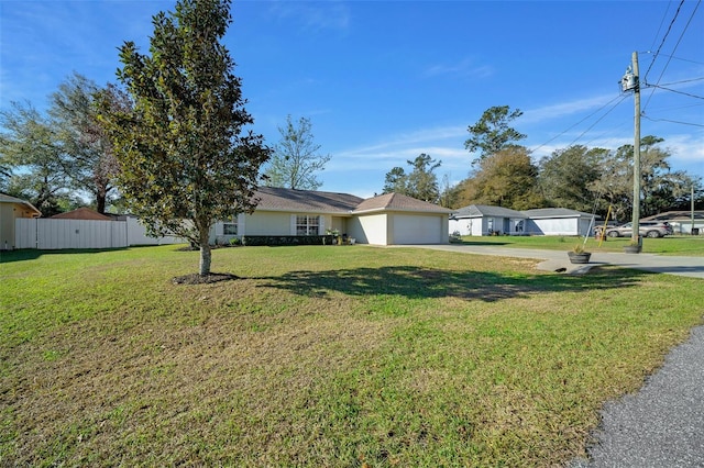 single story home featuring a garage, driveway, fence, and a front lawn