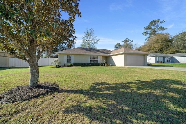 ranch-style house with an attached garage, fence, driveway, stucco siding, and a front yard