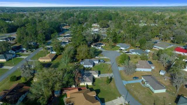 drone / aerial view with a forest view and a residential view