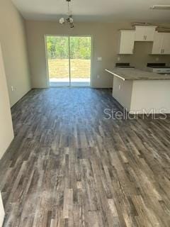 kitchen featuring white cabinetry, dark wood-type flooring, and open floor plan