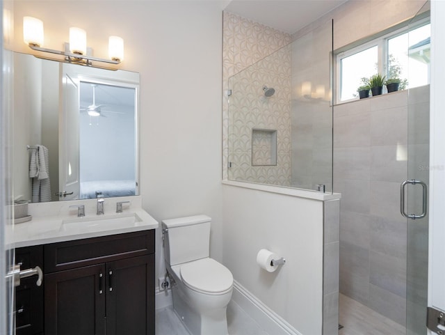 full bathroom featuring toilet, vanity, and a walk in shower