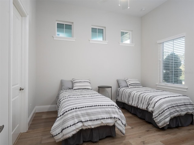 bedroom with baseboards and wood finished floors