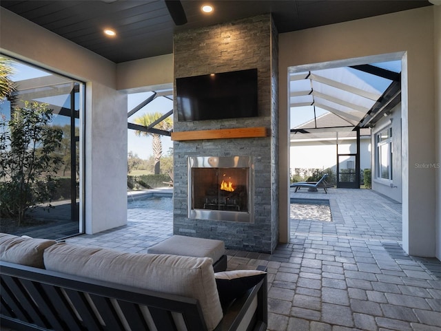 exterior space featuring a lanai and an outdoor stone fireplace