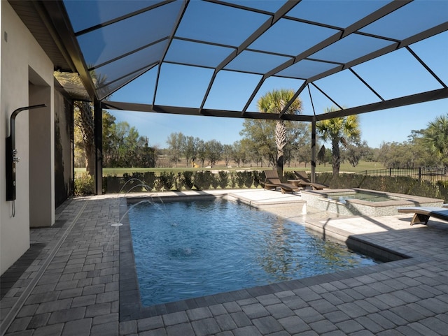 view of pool with a patio, a lanai, and a pool with connected hot tub