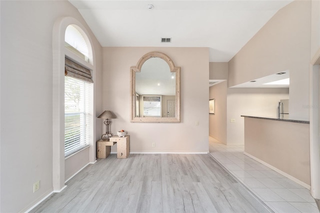 unfurnished room with light wood-style flooring, visible vents, and baseboards