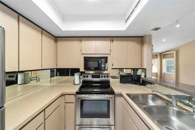 kitchen with cream cabinetry, visible vents, electric range, a sink, and black microwave