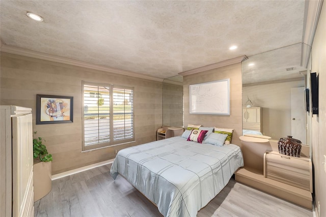 bedroom featuring recessed lighting, crown molding, baseboards, and wood finished floors