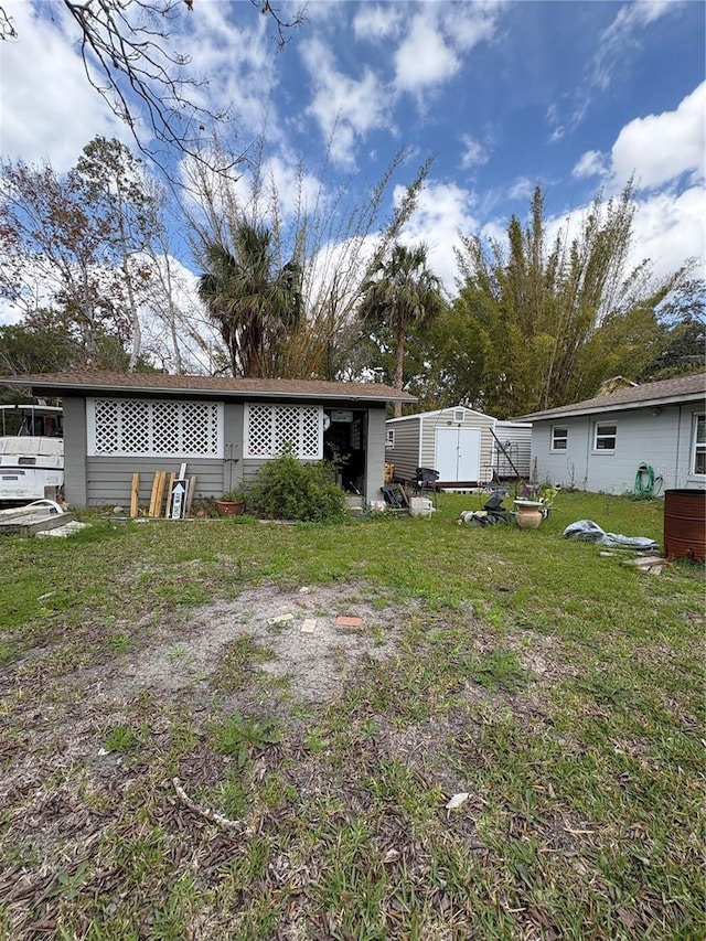 back of property featuring a lawn