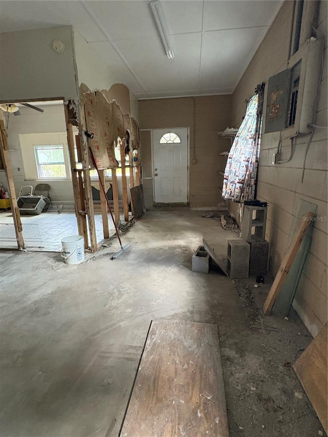 interior space featuring concrete flooring and concrete block wall