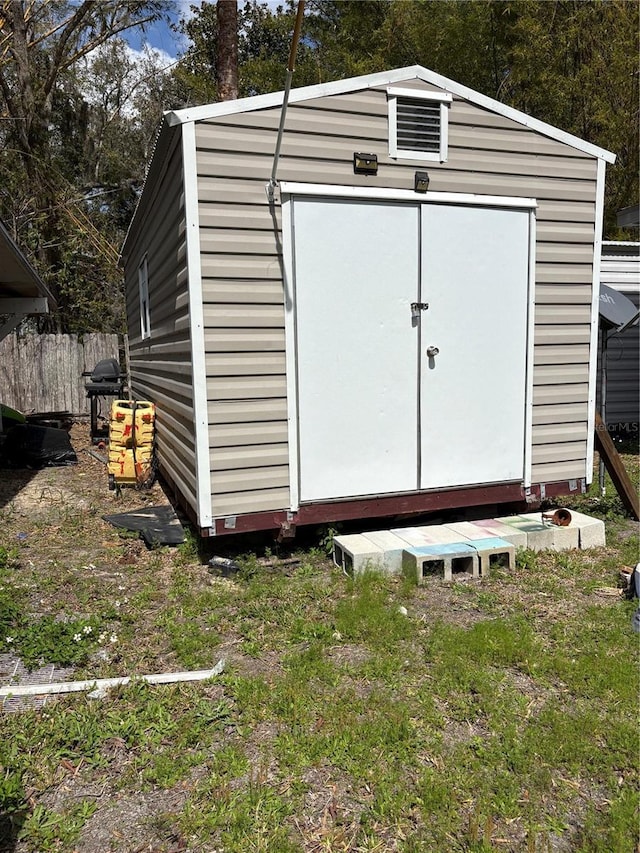 view of shed featuring fence