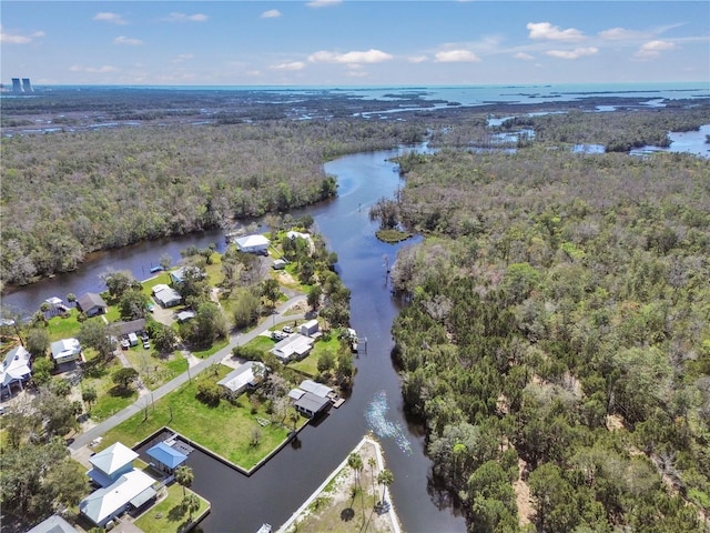 aerial view with a forest view and a water view