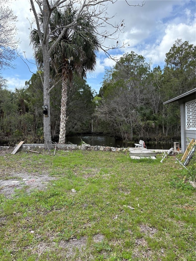 view of yard with a view of trees