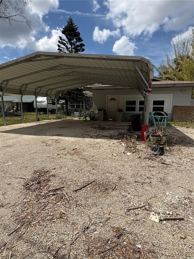 exterior space featuring a carport and driveway