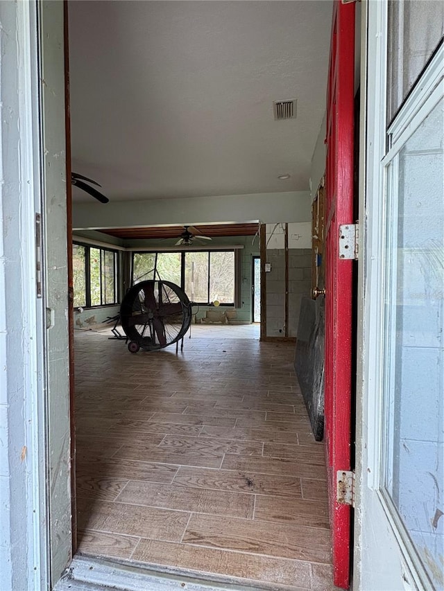 interior space with plenty of natural light, wood finished floors, and visible vents