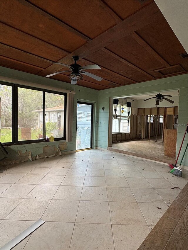 unfurnished sunroom with ceiling fan