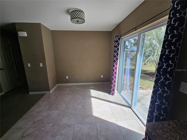 interior space featuring tile patterned flooring and baseboards