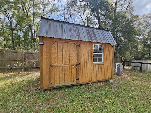 view of shed featuring fence