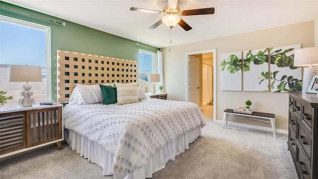 bedroom with light carpet, ceiling fan, and baseboards